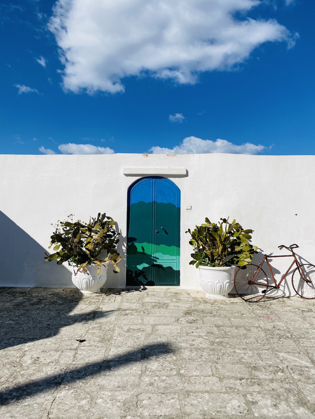 the famous blue door in the white wall in Ostuni